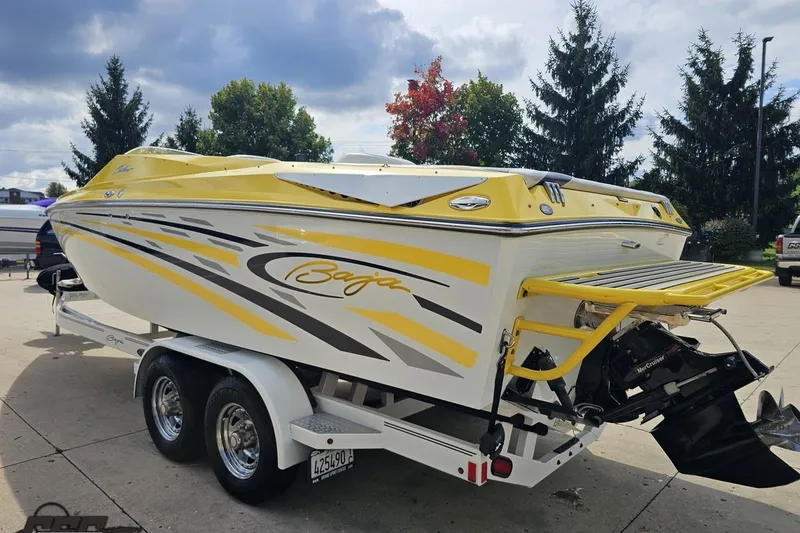 Slide: The Image of 2007 Baja 26 Outlaw boat with yellow and white design on a trailer. - 29