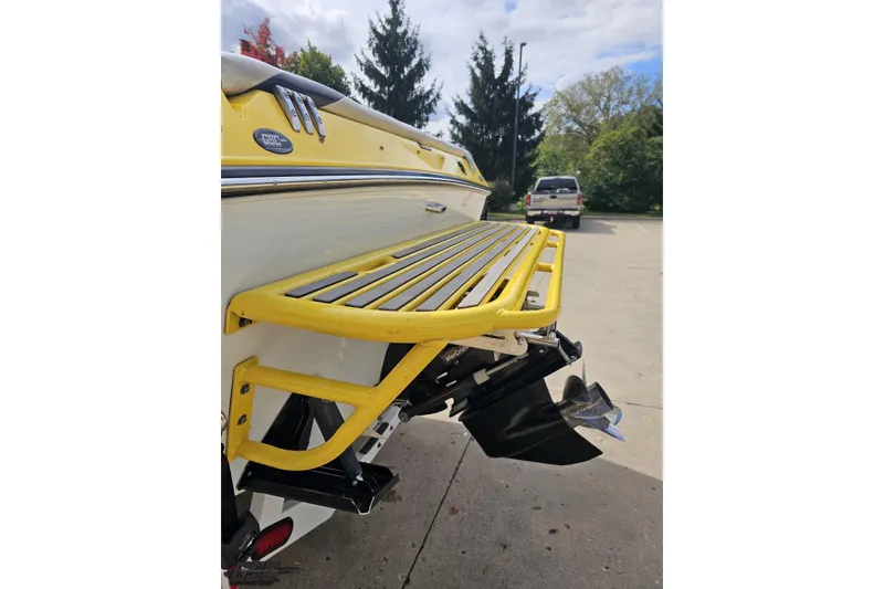 Slide: The Image of 2007 Baja 26 Outlaw boat with yellow swim platform and outboard motor. - 30