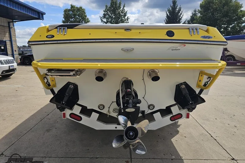 Slide: The Image of Rear view of a 2007 Baja 26 Outlaw boat with yellow accents and dual propellers. - 31