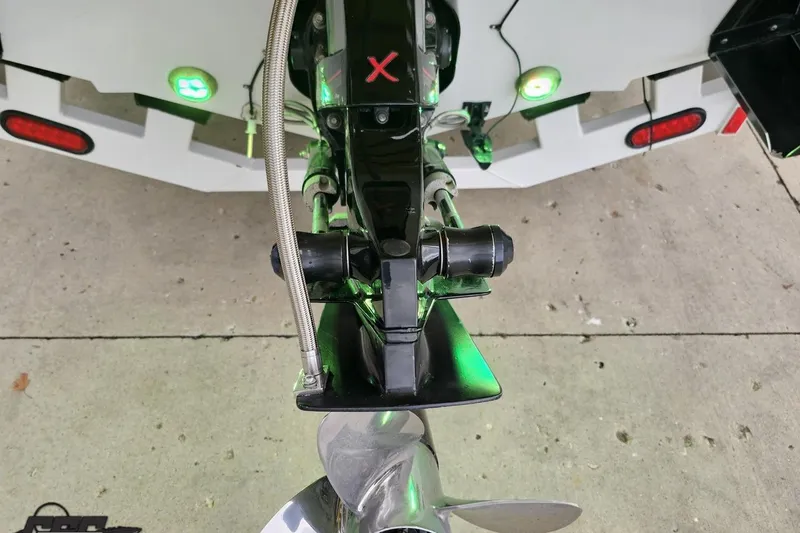 Slide: The Image of Rear view of a 2007 Baja 26 Outlaw boat with illuminated green lights. - 37