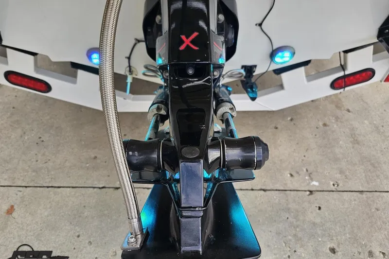 Slide: The Image of Rear view of a 2007 Baja 26 Outlaw boat with illuminated blue lights. - 38