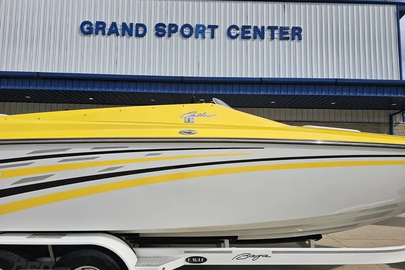 Slide: The Image of 2007 Baja 26 Outlaw boat in yellow and white at Grand Sport Center. - 4