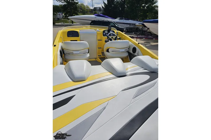 Slide: The Image of 2007 Baja 26 Outlaw boat interior with yellow and white seating, sleek design. - 42
