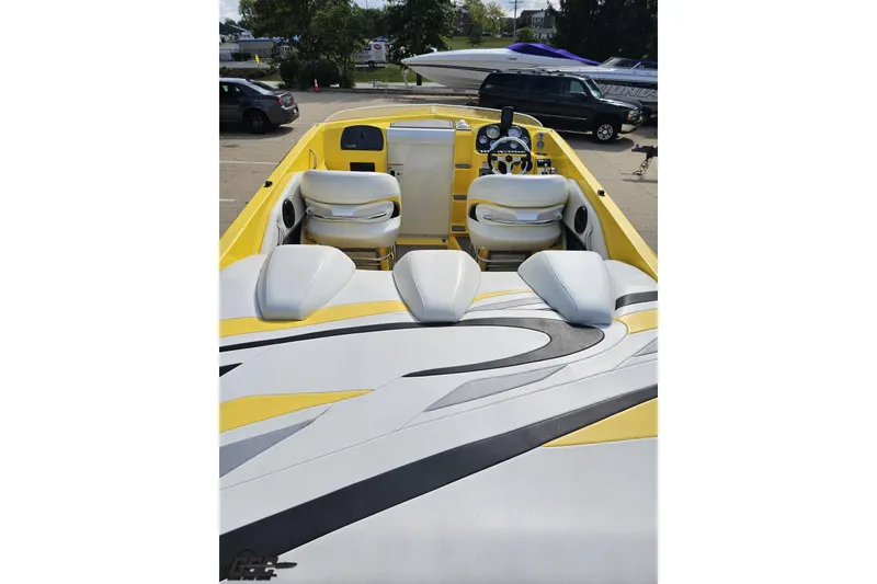 Slide: The Image of 2007 Baja 26 Outlaw boat with yellow and white interior, sleek design, and modern dashboard. - 43