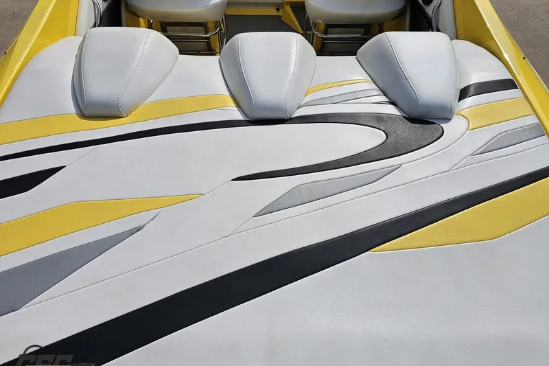 Slide: The Image of 2007 Baja 26 Outlaw boat interior with stylish yellow, black, and white upholstery design. - 44