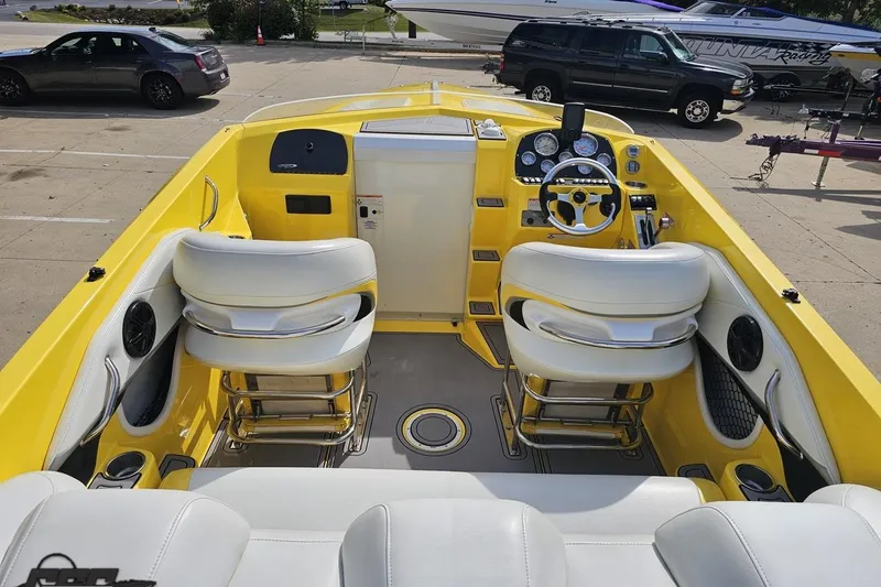 Slide: The Image of 2007 Baja 26 Outlaw boat interior with yellow accents and white seating. - 47