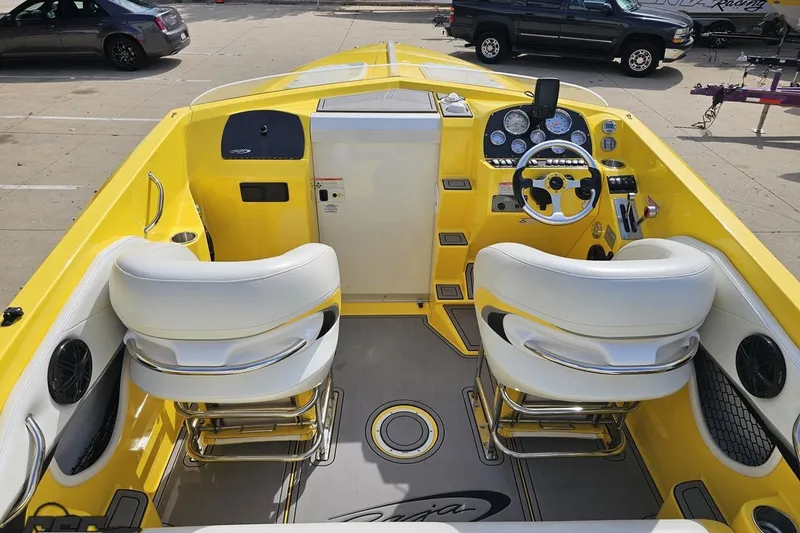 Slide: The Image of Yellow 2007 Baja 26 Outlaw boat interior with white seats and modern dashboard. - 48