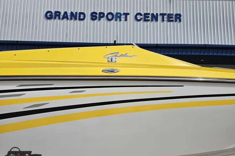 Slide: The Image of 2007 Baja 26 Outlaw boat with yellow and white design at Grand Sport Center. - 5