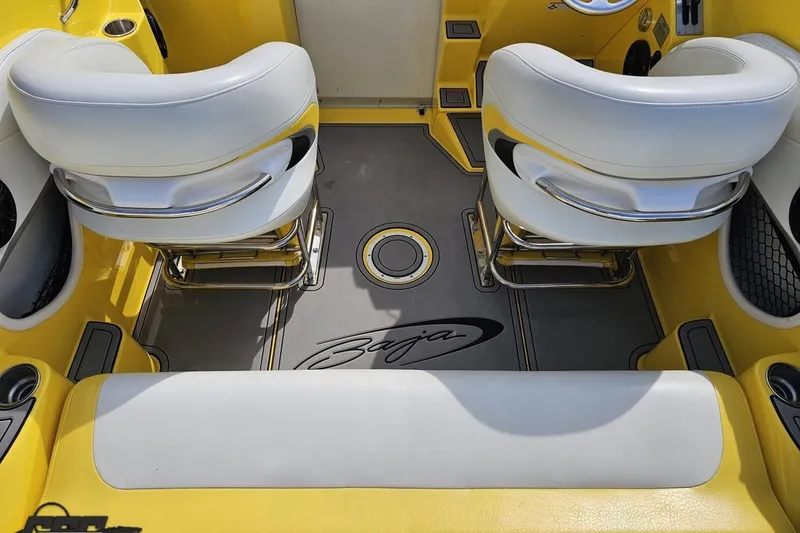 Slide: The Image of 2007 Baja 26 Outlaw boat interior with yellow and white seating and Baja logo. - 50