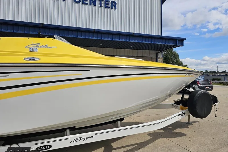 Slide: The Image of 2007 Baja 26 Outlaw boat with yellow and white design on a trailer. - 6