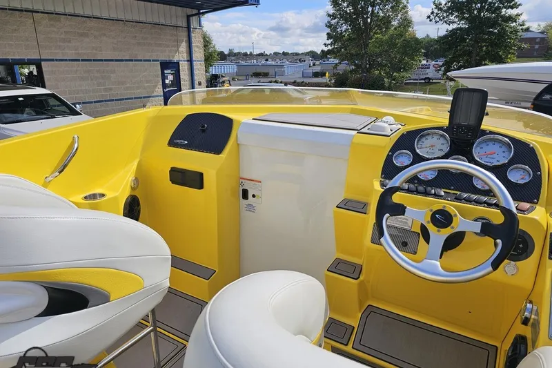 Slide: The Image of 2007 Baja 26 Outlaw boat cockpit with yellow dashboard and steering wheel. - 61