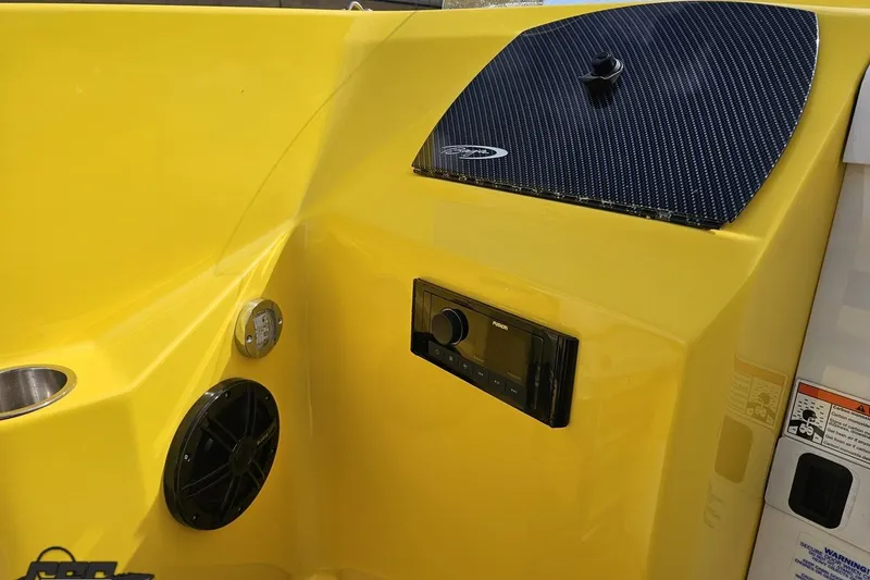 Slide: The Image of 2007 Baja 26 Outlaw boat interior with yellow panel, speaker, and control system. - 63
