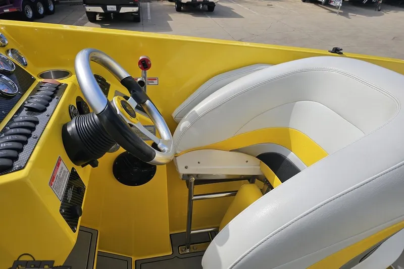 Slide: The Image of 2007 Baja 26 Outlaw boat interior with yellow and white seating and steering wheel. - 65