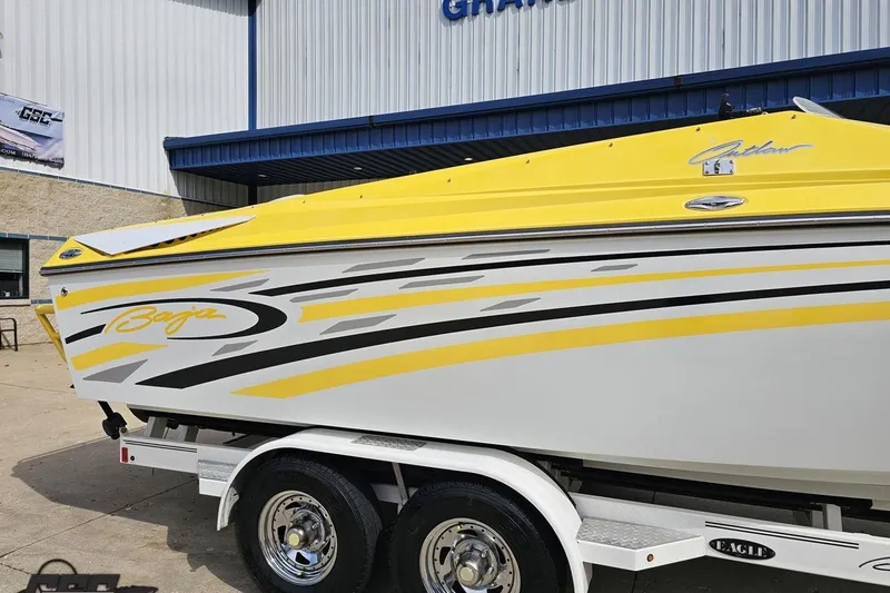 Slide: The Image of 2007 Baja 26 Outlaw boat with yellow and white design on a trailer. - 7