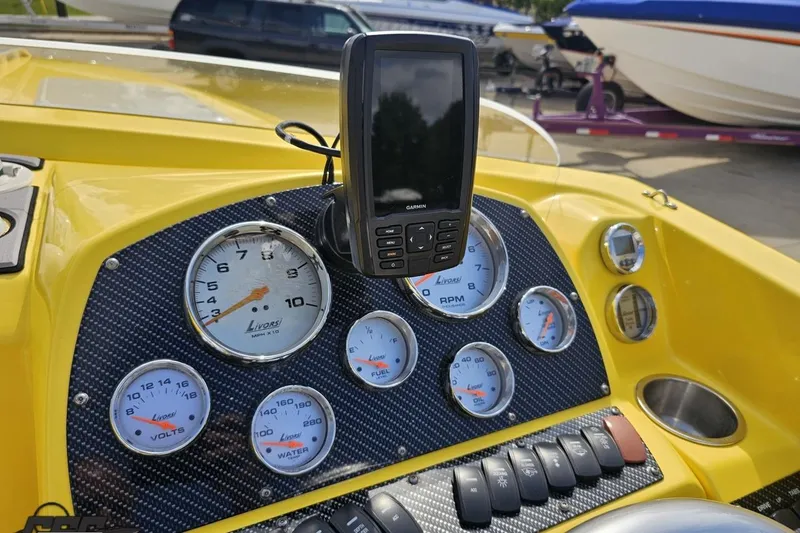 Slide: The Image of Dashboard of a 2007 Baja 26 Outlaw boat with gauges and GPS device. - 70
