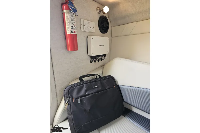 Slide: The Image of Interior of 2007 Baja 26 Outlaw boat with fire extinguisher and black bag. - 79