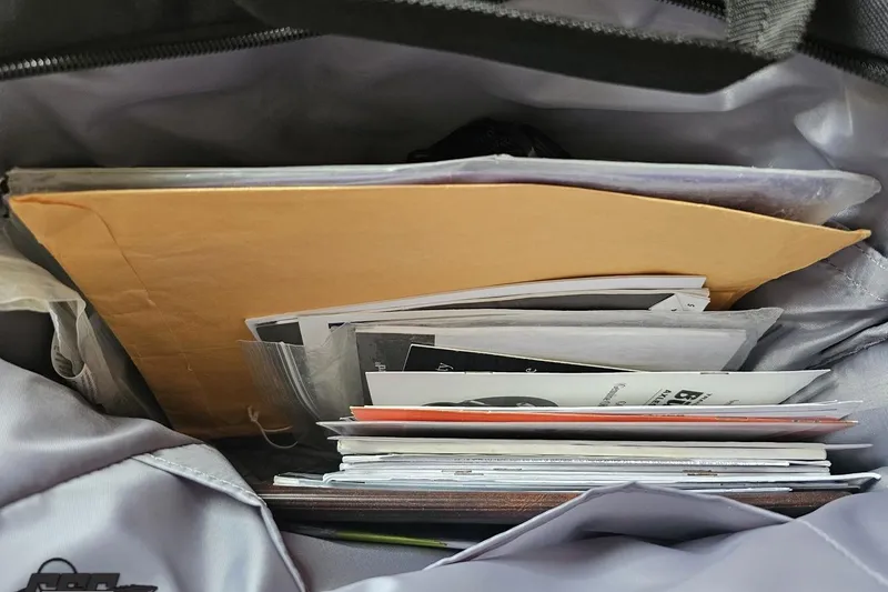 Slide: The Image of Bag filled with documents and folders, including Baja 26 Outlaw 2007 paperwork. - 81