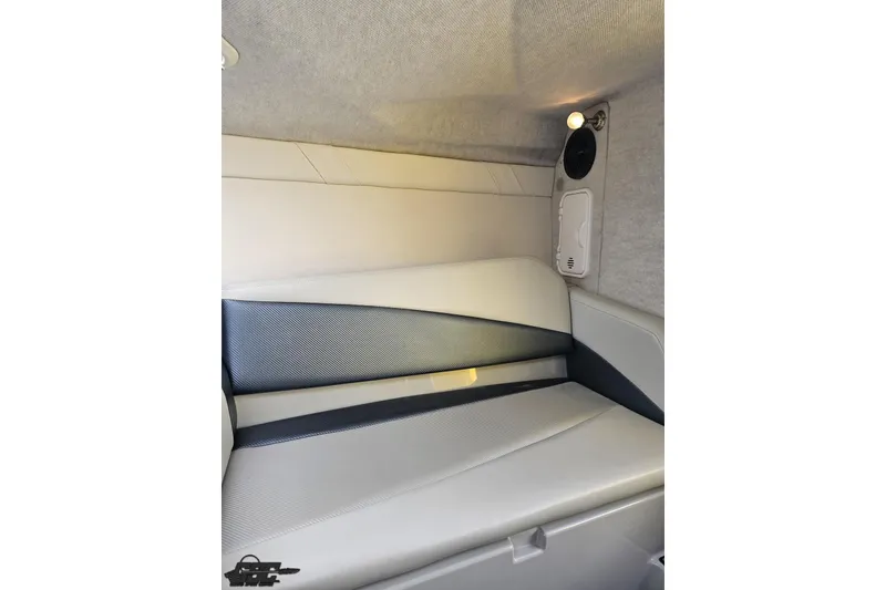 Slide: The Image of Interior cabin of 2007 Baja 26 Outlaw boat, featuring cushioned seating and speaker. - 84