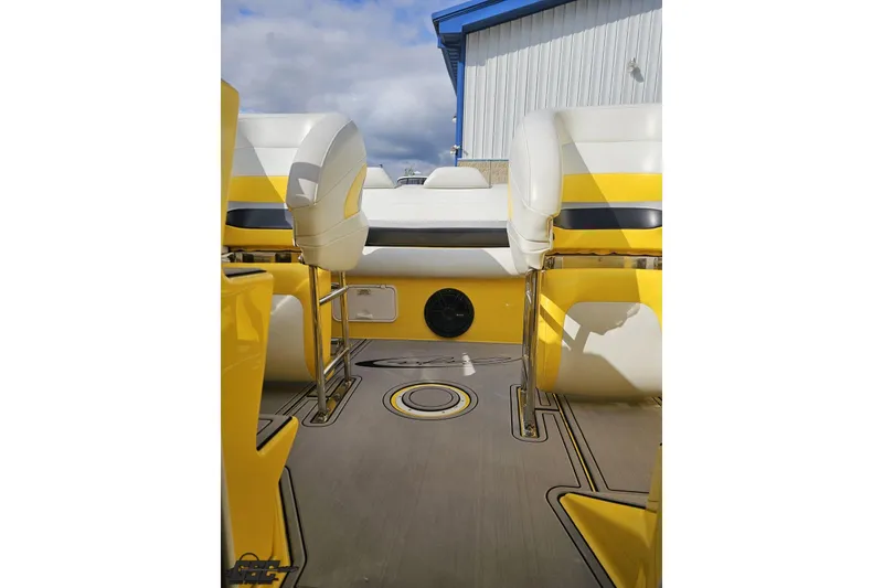Slide: The Image of 2007 Baja 26 Outlaw boat interior with yellow and white seating, outdoor setting. - 85