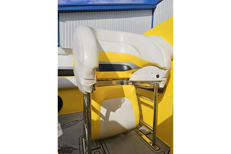 Slide: The Image of Yellow and white seat on 2007 Baja 26 Outlaw boat, featuring sleek design and chrome accents. - 86