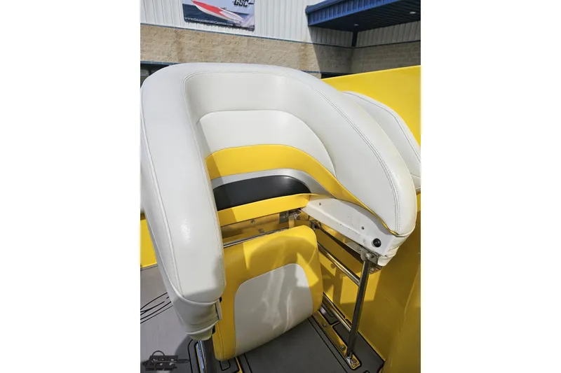 Slide: The Image of 2007 Baja 26 Outlaw boat seat with white and yellow upholstery. - 87