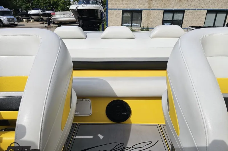 Slide: The Image of Interior of 2007 Baja 26 Outlaw boat with white and yellow seating. - 90