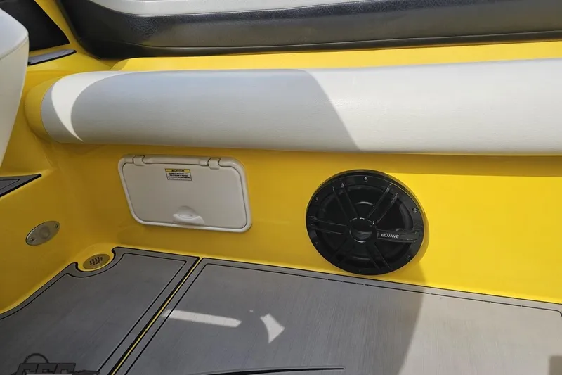 Slide: The Image of 2007 Baja 26 Outlaw boat interior with yellow paneling and speaker. - 92