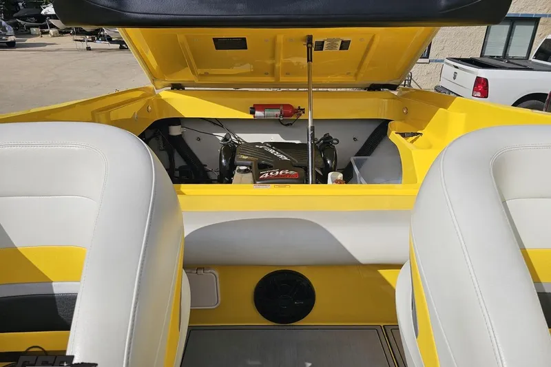 Slide: The Image of 2007 Baja 26 Outlaw boat engine compartment with yellow and white interior. - 94
