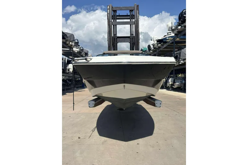 Slide: The Image of 2020 NauticStar 223 DC boat on a dock, viewed from the front. - 10