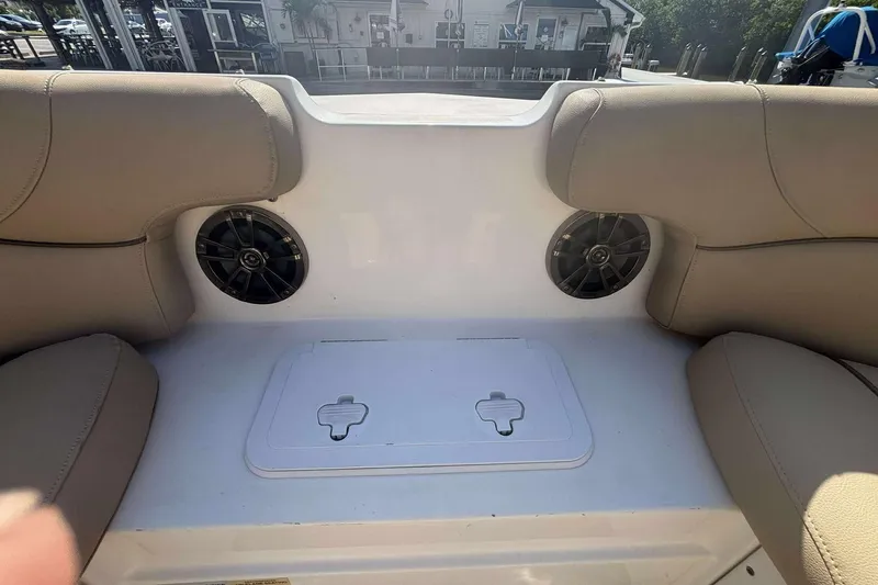 Slide: The Image of Interior of 2020 NauticStar 223 DC boat with beige seating and built-in speakers. - 13