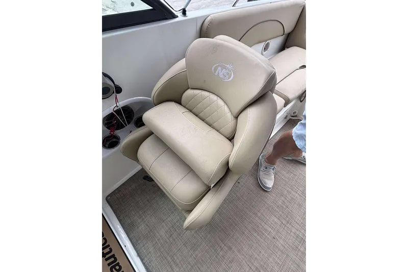 Slide: The Image of Beige captain's chair on 2020 NauticStar 223 DC boat, featuring embroidered logo. - 17