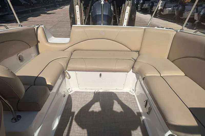 Slide: The Image of 2020 NauticStar 223 DC boat interior with beige seating and spacious layout. - 18