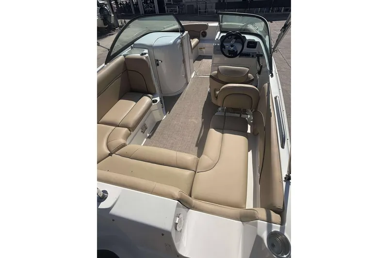 Slide: The Image of 2020 NauticStar 223 DC boat interior with beige seating and steering console. - 21