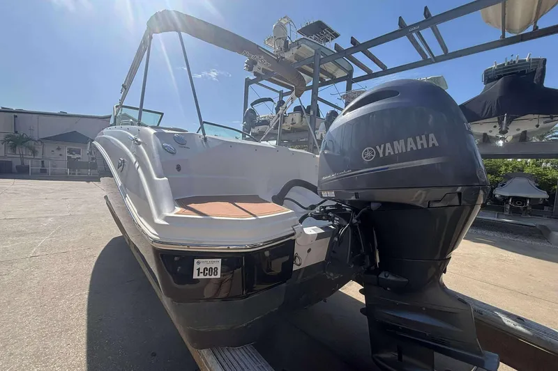 Slide: The Image of 2020 NauticStar 223 DC boat with Yamaha outboard motor in a sunny marina. - 27