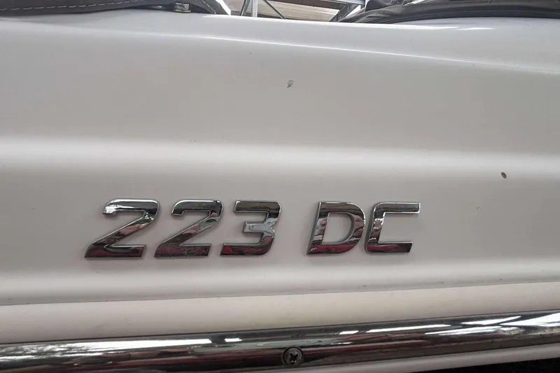 Slide: The Image of NauticStar 223 DC boat emblem, 2020 model, chrome lettering on white surface. - 8