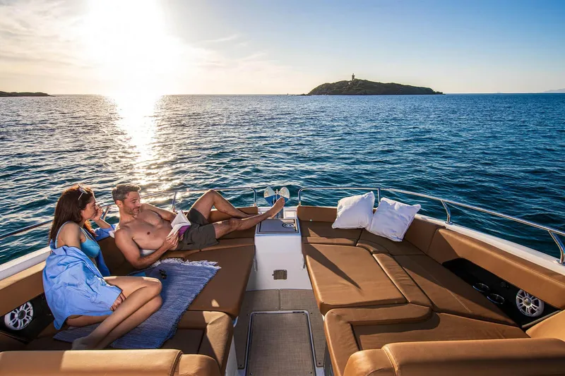 Slide: The Image of Manufacturer Provided Image: Couple relaxing on 2026 Four Winns TH38 yacht, enjoying sunset over the ocean. - 3