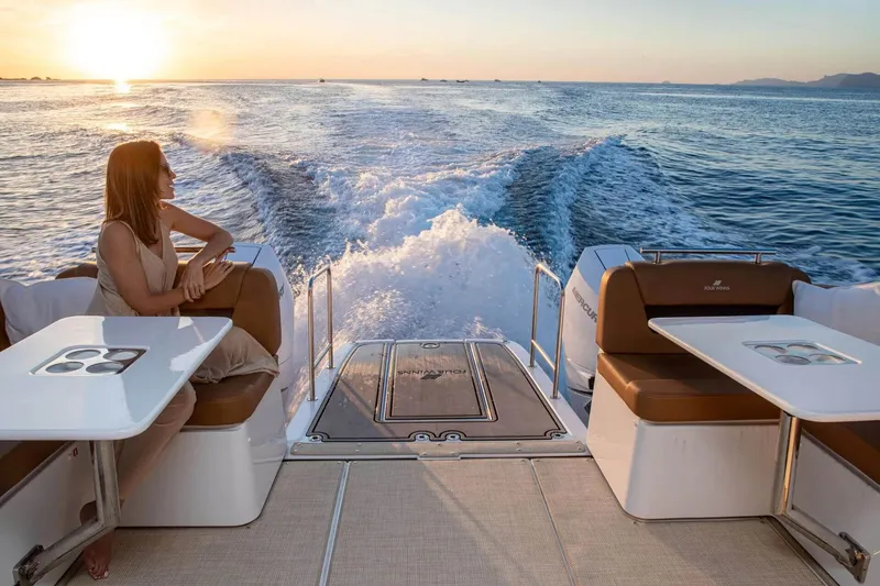 Slide: The Image of Manufacturer Provided Image: 2026 Four Winns TH38 boat cruising at sunset with a passenger enjoying the view. - 8