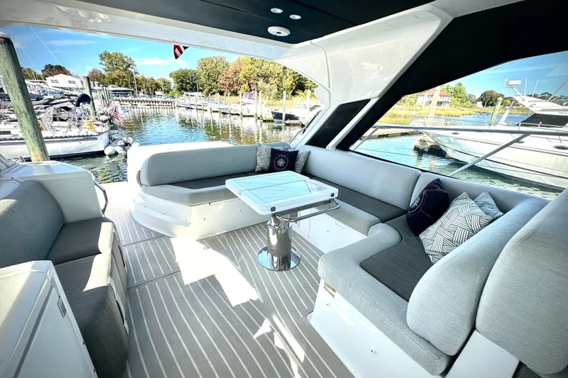 Slide: The Image of Luxurious 2019 Azimut Atlantis 51 yacht interior with elegant seating and scenic marina view. - 12