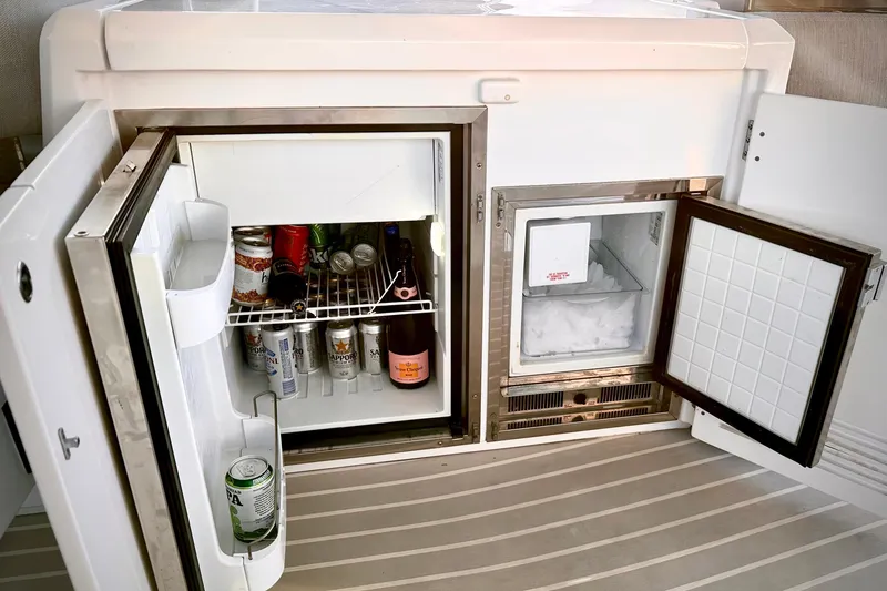Slide: The Image of Refrigerator and ice maker on 2019 Azimut Atlantis 51 yacht, stocked with beverages. - 15