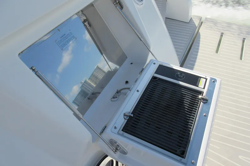 Slide: The Image of Outdoor grill on 2019 Azimut Atlantis 51 yacht deck, reflecting sky and buildings. - 16