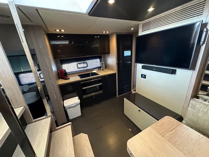 Slide: The Image of Luxurious interior of 2019 Azimut Atlantis 51 yacht with modern kitchen and entertainment area. - 19