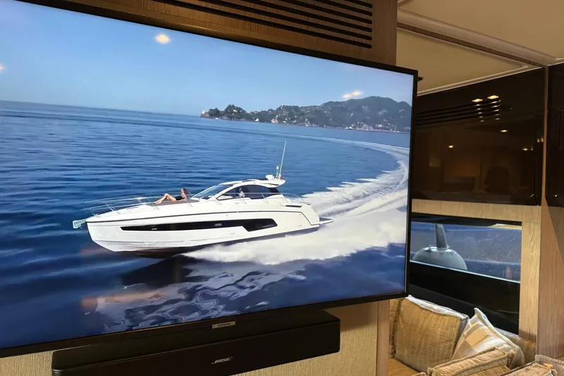 Slide: The Image of 2019 Azimut Atlantis 51 yacht cruising on open water, displayed on a screen indoors. - 24