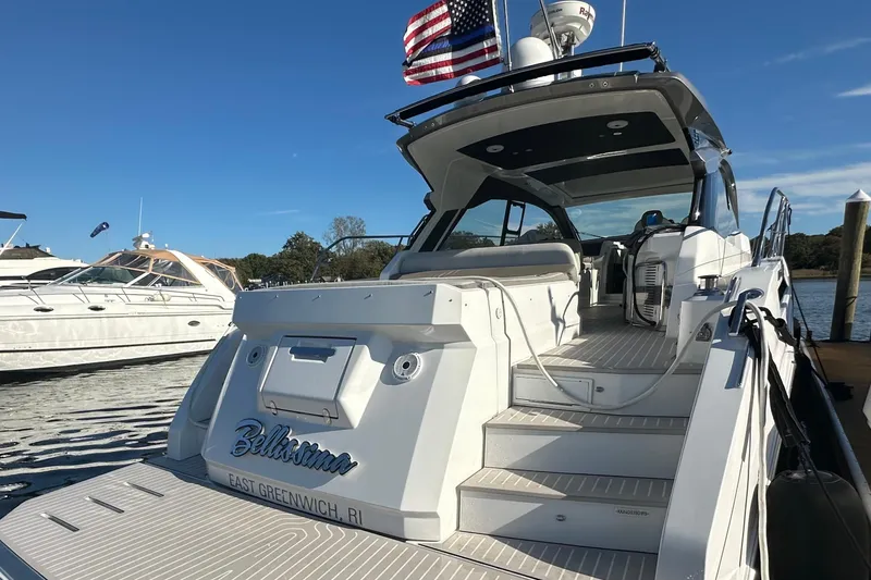Slide: The Image of 2019 Azimut Atlantis 51 yacht docked, rear view with American flag, sunny day. - 3