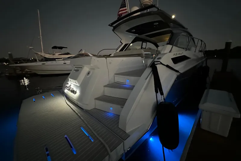 Slide: The Image of 2019 Azimut Atlantis 51 yacht docked at night with blue underwater lights. - 5