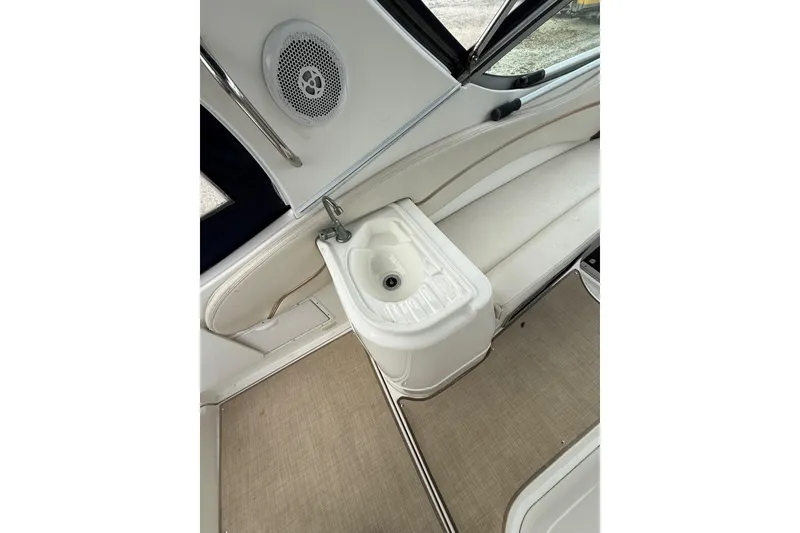 Slide: The Image of 2005 Larson Cabrio 290 boat interior with sink and seating area. - 11