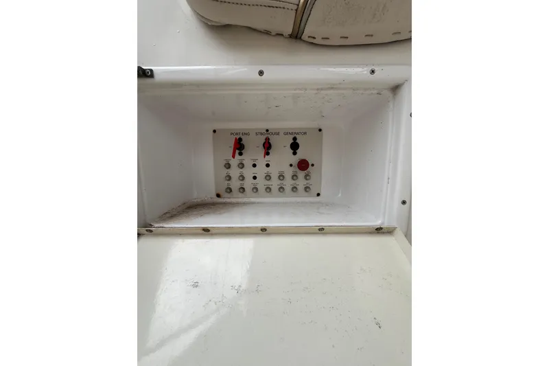 Slide: The Image of Control panel of a 2005 Larson Cabrio 290 boat, featuring switches and buttons. - 12