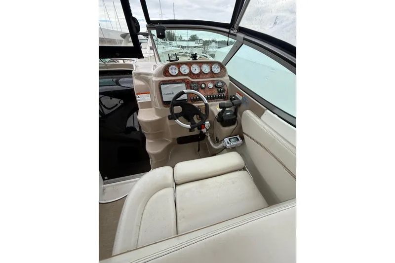 Slide: The Image of 2005 Larson Cabrio 290 boat cockpit with steering wheel and control panel. - 14
