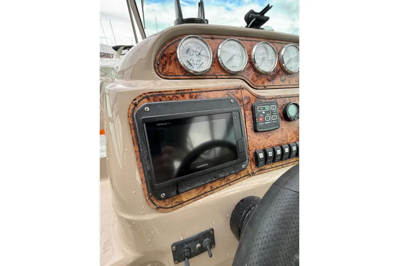 Slide: The Image of Dashboard of a 2005 Larson Cabrio 290 boat with gauges and Garmin GPS. - 17