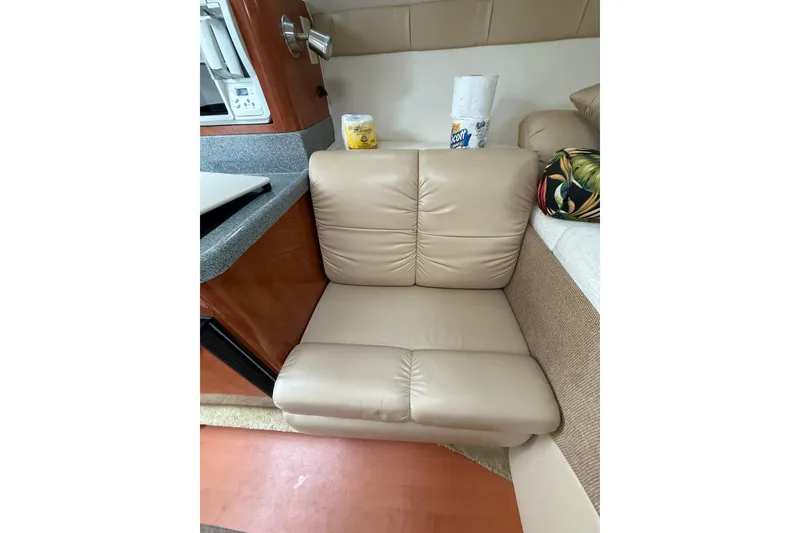 Slide: The Image of Beige leather seating in 2005 Larson Cabrio 290 boat interior, with countertop and paper towels. - 25