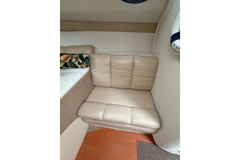 Slide: The Image of 2005 Larson Cabrio 290 interior with beige leather seating and decorative pillow. - 26